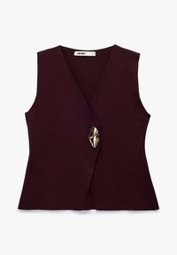 Mouwloos donker bordeauxkleurig gebreid vest met diepe V-hals en een enkele, onregelmatig gevormde glanzende metalen gesp aan de voorkant.
