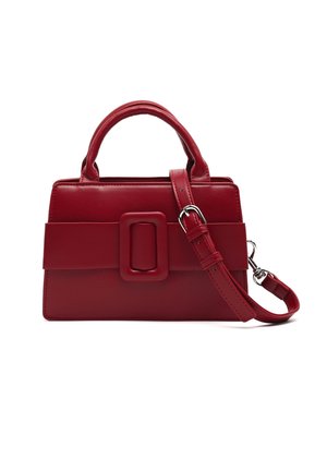 Red leather handbag with a rectangular shape, featuring a large buckle accent and dual handles. Includes a detachable strap.
