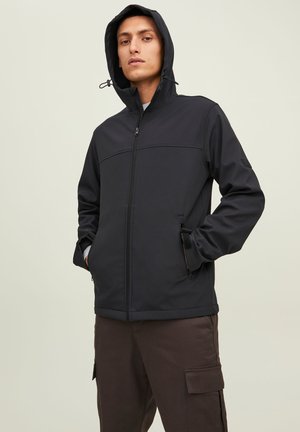 Black zip-up jacket with a hood, featuring a panel design and side pockets. Material appears smooth and matte. Minimalist style.
