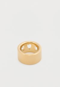 Δαχτυλίδι από μεταλλικό υλικό σε χρυσή απόχρωση με λείο, γυαλιστερό εξωτερικό. Το εσωτερικό έχει κομμένες καρδιές, δημιουργώντας διακοσμητικό μοτίβο.