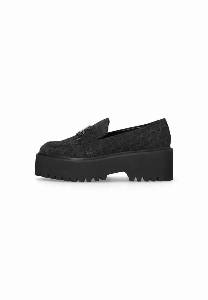 Mocassin noir à enfiler avec semelle épaisse à crampons, tissu subtilement imprimé et boucle métallique décorative sur le dessus.