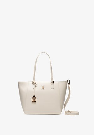 Sac fourre-tout en cuir beige avec double poignées, une bandoulière amovible et un petit emblème doré en forme de cheval sur le devant.