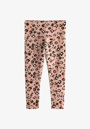 Legíny s leopardím potiskem na světle růžovém pozadí, vyrobené z měkké látky, s černými, hnědými a bílými skvrnami s květinovými akcenty.