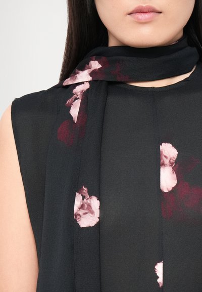 Black chiffon scarf with pink and burgundy floral prints, draped around the neck, featuring a smooth texture and elegant design.
