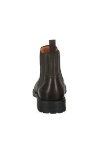Braune Leder-Stiefeletten mit glatter Oberfläche, elastischen Seitenpanelen und einer schwarzen Gummisohle. Mit einer Zuglasche hinten für einfaches Anziehen.