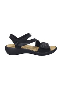 Zwarte suède sandaal met een ronde neus, verstelbaar bandje, gevoerd voetbed en een lichte wig hiel. Heeft witte stikselaccenten.