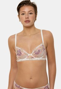 Soutien-gorge en dentelle blanche avec broderie florale en rose et violet, doté de bretelles réglables et d'un détail décolleté en forme de clé.