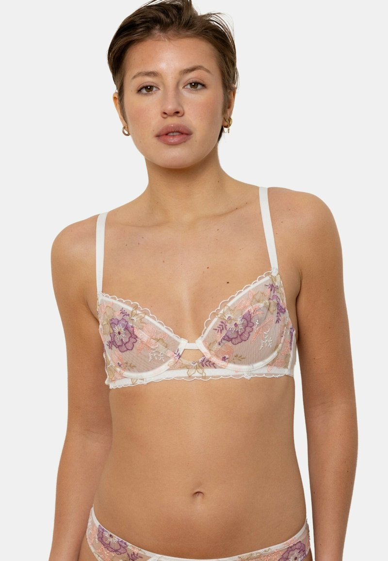 Soutien-gorge en dentelle blanche avec broderie florale en rose et violet, doté de bretelles réglables et d'un détail décolleté en forme de clé.