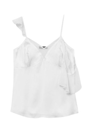 Blouse blanche sans manches avec un décolleté en V, une bretelle à volants et une texture satinée lisse. Présente une coupe décontractée et des fentes sur les côtés.