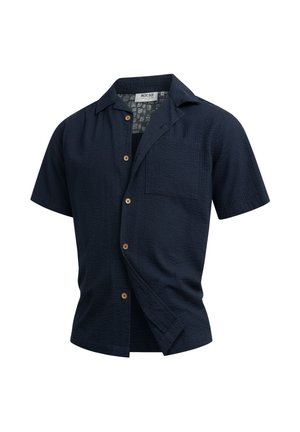 Camisa texturizada de manga corta en azul marino con botones al frente y bolsillo en el pecho, abierta en la parte inferior.