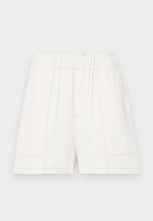 White cotton shorts with an elastic waistband, featuring side pockets and visible seam detailing for added texture.