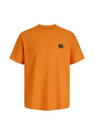 Bright orange short-sleeve textured crewneck T-shirt with a small dark square logo patch on the left chest.