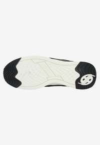 Black and white athletic shoe sole featuring textured patterns for grip, flexible rubber material, and distinctive logo detail.