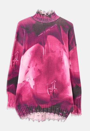 Oversized knit sweater in shades of pink with floral design, ribbed high collar, and ruffled hem. Features subtle text and textured pattern.