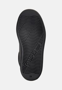 Semelle de chaussure en caoutchouc noir avec une texture ondulée et un logo indiquant "CAMPER." Taille indiquée comme "28." Conçue pour l'adhérence et la durabilité.