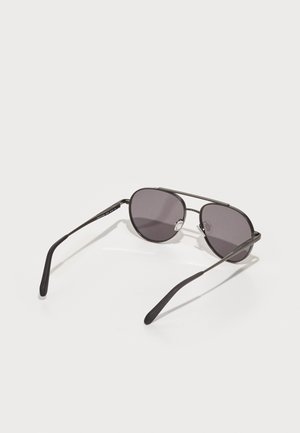 Sunglasses with a metallic black frame, oval lenses in dark gray, and slim, curved arms. Features a double bridge accent.