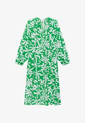 Robe verte avec des motifs blancs en forme de feuilles. Manches longues, encolure froncée et coupe loose. Fabriquée en tissu léger et texturé.