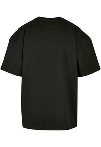 Zwarte oversized katoenen t-shirt met korte mouwen en een ronde halslijn. Soepele textuur met een eenvoudig, onopgesmukt ontwerp.