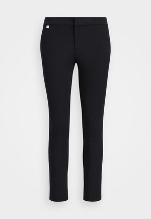 Slim-fit sorte bukser laget av elastisk stoff. Har en jevn midje og subtil merkevare. Ingen lommer eller synlige sømmer.