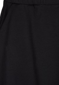 Mustapaita, joka on valmistettu pehmeästä ja joustavasta kankaasta. Ominaisuuksiin kuuluu yksinkertainen muotoilu, jossa on joustava vyötärö. Sileä pinta, ilman kuvioita tai yksityiskohtia.