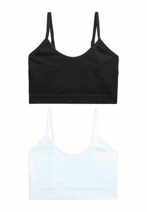 Twee naadloze geribbelde cropped tops met dunne bandjes, één in zwart en één in wit, weergegeven op een witte achtergrond.