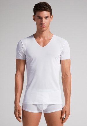 White short-sleeve V-neck t-shirt made from a smooth, lightweight fabric, paired with white fitted briefs, displaying a clean, minimalist design.