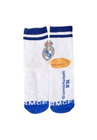 Calze bianche con accenti blu e oro, con logo del Real Madrid. Texture a coste, strisce blu sulla parte superiore e branding stampato sul lato.