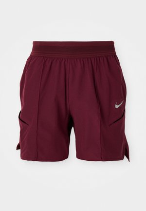 Burgundy athletic shorts with elastic waistband, side slits, and reflective Nike swoosh logo on the right leg.