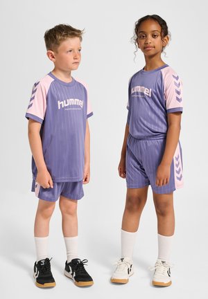 Purple sportswear set featuring vertical stripes, pink sleeves, and logo; includes shorts and matching top with chevron accents.