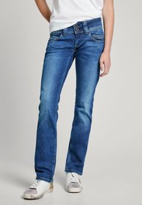 Blå denimjeans med rak passform, utrustade med stängning med två knappar, femfickorsdesign och subtil blekning på låren.