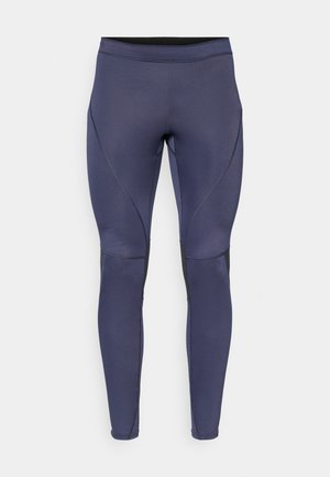 Leggings sportivi blu navy realizzati in tessuto elasticizzato, con una vita alta, pannelli neri laterali e dettagli con cuciture curve.