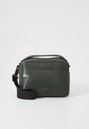 Green waterproof crossbody bag made of smooth material, featuring a black adjustable strap and a subtle embossed logo at the front.