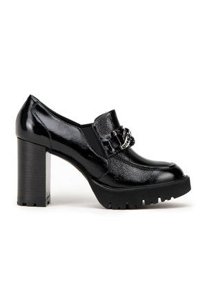 Black high-heeled shoe made of glossy synthetic material, featuring a chunky heel, rounded toe, and decorative metallic hardware on the vamp.