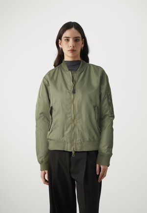 Olive green bomber jacket in smooth nylon with ribbed cuffs and hem, featuring a front zipper and side pockets, designed with a minimal aesthetic.