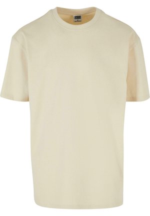 T-shirt en coton beige avec un col rond et des manches courtes. Design simple et texture douce, adapté à une tenue décontractée.
