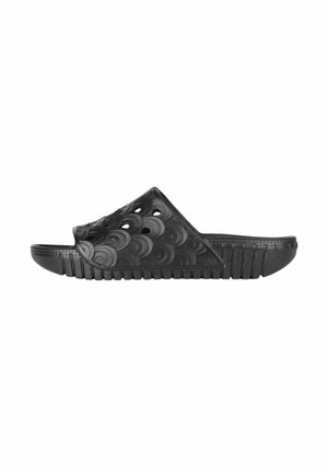 Black rubber slide sandal featuring a wavy textured upper with circular cutouts, a cushioned footbed, and a ridged sole for grip.
