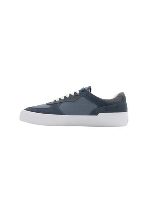 Navy canvas and suede sneaker with white laces, rubber sole, and a textured finish. Features a smooth silhouette and contrasting accents.