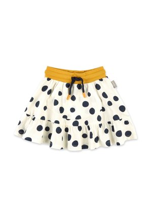 Jupe blanche à grands pois noirs, taille élastique jaune moutarde, cordon noir avec extrémités orange, et ourlet froncé.