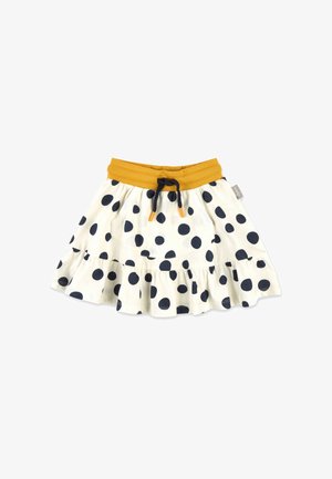 Weißer Rock mit großen schwarzen Polka-Dots, senfgelbem elastischem Bund, schwarzem Kordelzug mit orangen Spitzen und gerafftem Saum.