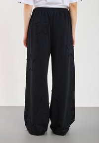 YOURTURN UNISEX - Teplákové kalhoty - black
