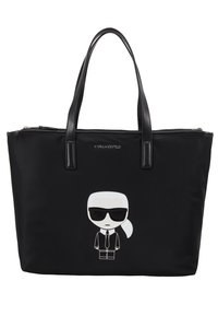 Svart nylon shoppingväska med två svarta handtag, prydd med en vit tecknad figur i solglasögon på framsidan. Dubbel dragkedja.