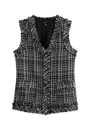 Gilet en tweed noir et blanc avec un motif texturé, comportant un décolleté en V, cinq boutons et deux poches avant avec des accents de boutons. Bords effilochés.