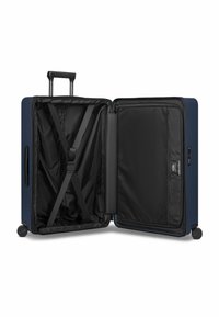 Maleta rígida azul marino con interior con cremallera, bolsillo de malla y correas cruzadas. Cuatro ruedas y asa retráctil para facilitar el transporte.