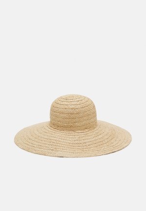 Wide-brimmed, natural-colored woven straw hat with a rounded crown, designed to provide sun protection.