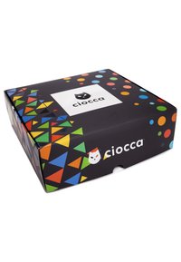 Scatola nera con motivi geometrici colorati e pois. Presenta un logo bianco in cima con un volto di gatto illustrato.