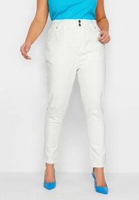 White, fitted pants with an elastic waistband, two front pockets, and two buttons. Smooth texture and ankle-length design.