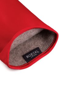 Red glove with soft gray wool lining, open cuff showing black "ROECKL MÜNCHEN" brand label inside.