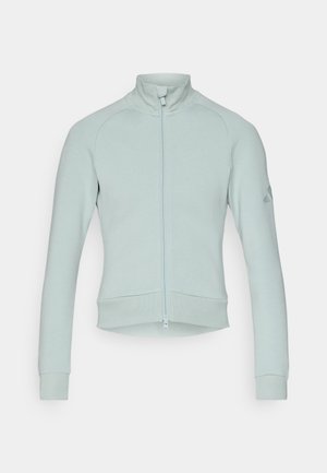 Felpa azzurro chiaro con zip, collo alto, polsini a costine e design cropped, realizzata in tessuto morbido, con un logo discreto sulla manica.