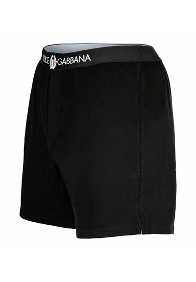 Svarta bomullskalsonger med mjuk textur, utrustade med elastisk midjeband som har "DOLCE & GABBANA" logodesign. Klassisk och enkel design.