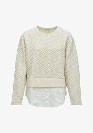 Maglione lungo a maniche lunghe trapuntato color crema con motivo geometrico, orlo a coste e dettaglio con coda di camicia bianca attaccata sul fondo.